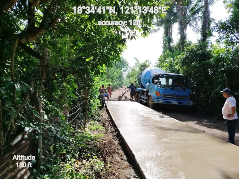 Freshly concreted road with a transit mixer and crew, geotagged field photo
