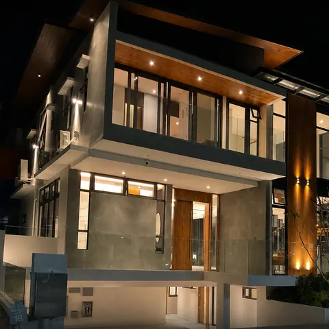 Concrete and timber facade lit at night